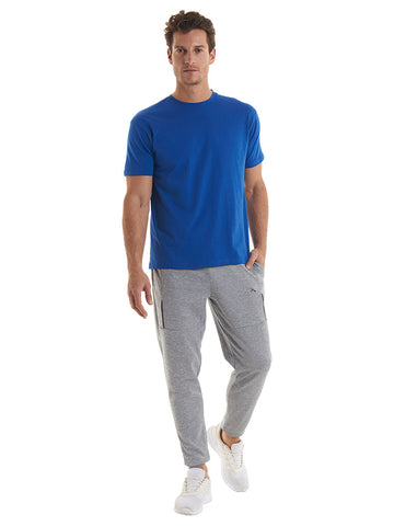 Blue T-Shirt worn with grey jogging bottoms by man. Custom Printing available.